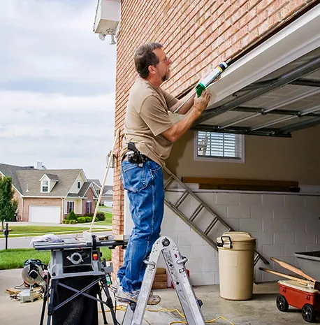 A technician repairing a garage door, highlighting the reliability of the garage door repair service.