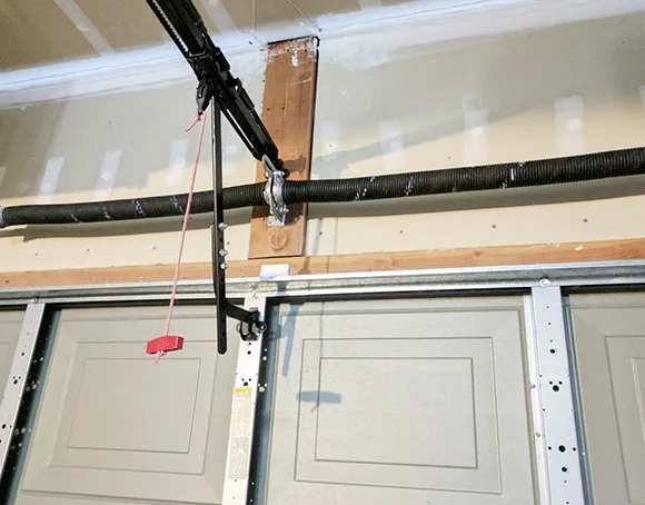 An image of a garage door with a torsion spring, highlighting professional installation services.