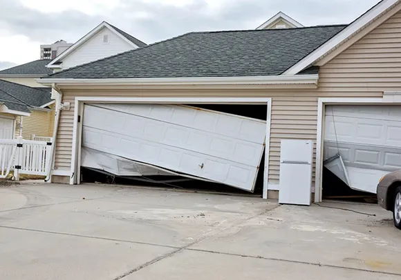 A damaged garage door on a house in Roseville, CA, highlighting the need for reliable 24/7 garage door repair.