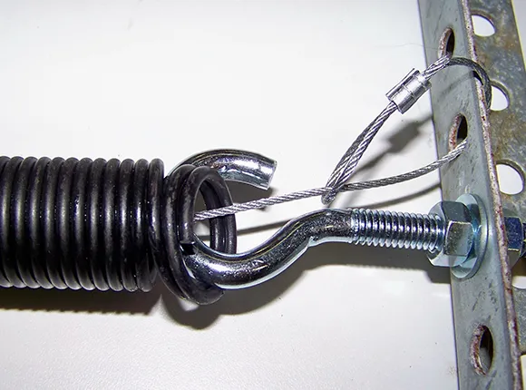 A close-up of a garage door torsion spring being adjusted, highlighting reliable garage door torsion spring repair in Lincoln, CA.